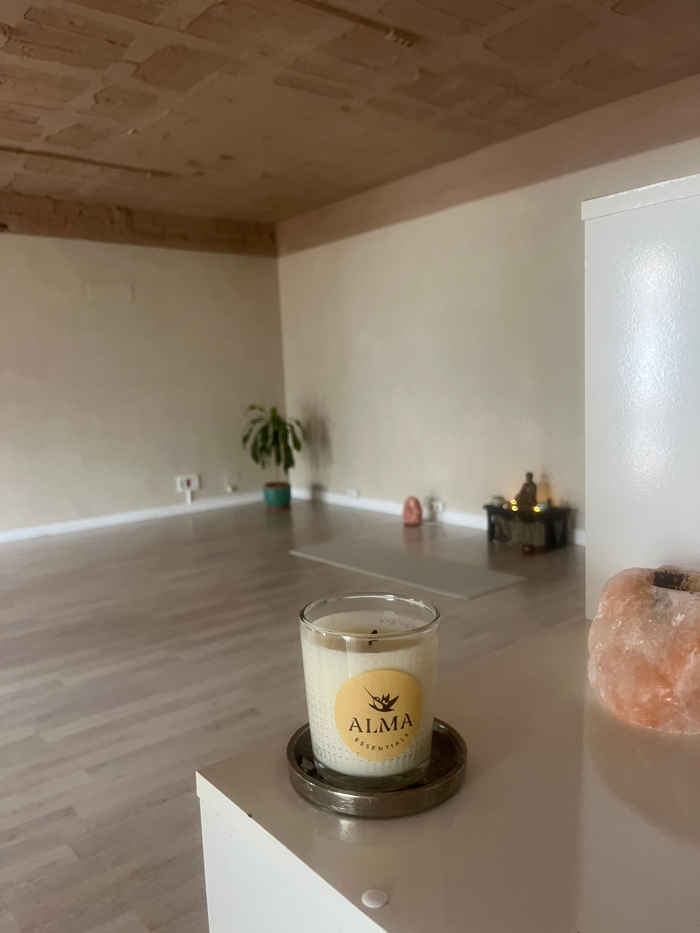 Inside The Sanctum Space studio in Nueva Andalucía, Marbella — candlelit with a yoga mat and salt lamp.